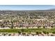 Wide aerial view of a community bordering a golf course with lush greenery and beautiful city views at 5436 Red Sun Dr, Las Vegas, NV 89149
