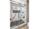 Modern shower features marble tile walls, black geometric floor tile and a small window at 5436 Red Sun Dr, Las Vegas, NV 89149