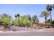 Painted Desert community entrance featuring lush landscaping, mature trees, and a decorative gate at 5436 Red Sun Dr, Las Vegas, NV 89149