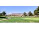 Picturesque view of the golf course with mountain views and lush green landscaping at 5436 Red Sun Dr, Las Vegas, NV 89149