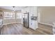 Bright eat-in kitchen boasts stainless steel appliances, white cabinets, and a breakfast nook with large windows at 5436 Red Sun Dr, Las Vegas, NV 89149