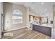 Open concept living space shows kitchen with island, large arched window and entry door at 5436 Red Sun Dr, Las Vegas, NV 89149