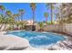 Backyard swimming pool surrounded by palm trees and a privacy wall at 5436 Red Sun Dr, Las Vegas, NV 89149