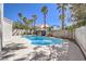 Relaxing backyard pool with palm trees and a modern, concrete privacy wall at 5436 Red Sun Dr, Las Vegas, NV 89149