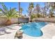 Inviting backyard pool with lush landscaping creating a private oasis at 5436 Red Sun Dr, Las Vegas, NV 89149