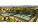 Aerial view of tennis courts showcasing the lush green surfaces, surrounding trees, and neighborhood at 5436 Red Sun Dr, Las Vegas, NV 89149