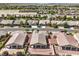 Aerial view of houses in a suburban neighborhood with desert landscaping and mountains in the background at 5500 E Volterra Dr, Pahrump, NV 89061