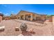 Wide open desert landscaped backyard including covered patio and firepit at 5500 E Volterra Dr, Pahrump, NV 89061