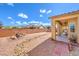 Low maintenance backyard, fully fenced with a covered patio and rock landscaping at 5500 E Volterra Dr, Pahrump, NV 89061