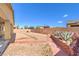 Expansive backyard with desert landscaping, brick accents, and a serene atmosphere at 5500 E Volterra Dr, Pahrump, NV 89061
