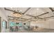 Large banquet hall with modern lighting, tables, chairs, and views to the outside at 5500 E Volterra Dr, Pahrump, NV 89061