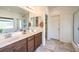 Bathroom features double sinks with stylish vanities, tile floors, and a glass-enclosed shower at 5500 E Volterra Dr, Pahrump, NV 89061