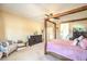 Spacious bedroom featuring a four-poster bed frame and a comfortable sitting area at 5500 E Volterra Dr, Pahrump, NV 89061