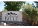 Stone monument with the Mountain Falls community name surrounded by desert landscaping and green trees at 5500 E Volterra Dr, Pahrump, NV 89061