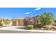 Charming single-story home featuring a three-car garage, a well-manicured front yard and desert landscaping at 5500 E Volterra Dr, Pahrump, NV 89061