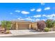 Exterior elevation of the home with multi-car garage and mature landscaping at 5500 E Volterra Dr, Pahrump, NV 89061