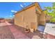 Image of the side of the house with rock landscaping, a brick pathway, and mountain views at 5500 E Volterra Dr, Pahrump, NV 89061