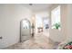 Bright entryway hallway featuring decorative mirror, clerestory window, and tile flooring at 5500 E Volterra Dr, Pahrump, NV 89061