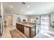 Open kitchen boasts granite countertops, stainless steel appliances, and breakfast bar seating at 5500 E Volterra Dr, Pahrump, NV 89061