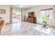 Open-concept living room with sliding glass door to backyard and a warm color palette at 5500 E Volterra Dr, Pahrump, NV 89061