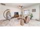 Open-concept living room features a cozy egg chair, ceiling fan, and natural light at 5500 E Volterra Dr, Pahrump, NV 89061