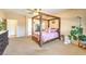 Large main bedroom with a four-poster bed, carpet flooring, and neutral paint at 5500 E Volterra Dr, Pahrump, NV 89061