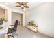 Bright home office with ceiling fan, neutral carpet, and adjacent bonus space at 5500 E Volterra Dr, Pahrump, NV 89061