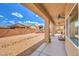 Covered patio looking out to the spacious backyard and desert landscaping at 5500 E Volterra Dr, Pahrump, NV 89061