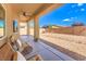 Covered patio area with ample seating and a view of the landscaped backyard at 5500 E Volterra Dr, Pahrump, NV 89061