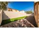 Spacious backyard featuring a brick-paved area, privacy wall, and artificial turf at 5575 Cresent Valley St, Las Vegas, NV 89148