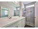 Modern bathroom with a double sink vanity, quartz countertop, and updated glass shower at 5575 Cresent Valley St, Las Vegas, NV 89148