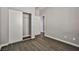 Bedroom with a large closet, featuring wood-look tile flooring and gray wall color at 5575 Cresent Valley St, Las Vegas, NV 89148