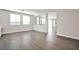 Open floor plan with wood-look floors and large windows at 5575 Cresent Valley St, Las Vegas, NV 89148