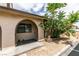 Charming home exterior featuring an arched entryway, complemented by flowering bushes at 5725 Smoke Ranch Rd # A, Las Vegas, NV 89108