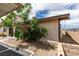 This charming home exterior showcases blooming roses, a neutral color scheme, and manicured landscaping at 5725 Smoke Ranch Rd # A, Las Vegas, NV 89108