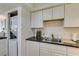 Galley kitchen boasts white cabinets, sleek countertops, and stainless steel sink and faucet at 5725 Smoke Ranch Rd # A, Las Vegas, NV 89108