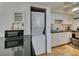 This kitchen is equipped with a modern washer/dryer combo unit and sleek black countertops at 5725 Smoke Ranch Rd # A, Las Vegas, NV 89108