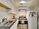 This modern kitchen features sleek appliances, ample countertop space and white cabinets at 5725 Smoke Ranch Rd # A, Las Vegas, NV 89108