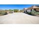Wide backyard view featuring a long driveway and vibrant landscaping, perfect for outdoor enjoyment at 5858 Majestic Tide Ave, Las Vegas, NV 89131