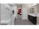 Bathroom features dual sinks, dark cabinets, glass enclosed shower and free standing tub at 5858 Majestic Tide Ave, Las Vegas, NV 89131