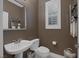 Powder room features large mirror, white sink and commode and plenty of open shelving at 5858 Majestic Tide Ave, Las Vegas, NV 89131