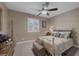 Relaxing bedroom has neutral carpet and walls, and window with plantation shutters at 5858 Majestic Tide Ave, Las Vegas, NV 89131