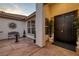Inviting front porch with a secure door, tile flooring, and desert landscaping elements at 5858 Majestic Tide Ave, Las Vegas, NV 89131