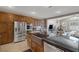 Open kitchen with stainless steel appliances, custom cabinets, and granite countertops at 5858 Majestic Tide Ave, Las Vegas, NV 89131
