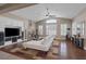 Inviting living room with a fireplace, hardwood floors, and large windows with plantation shutters at 5858 Majestic Tide Ave, Las Vegas, NV 89131
