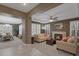 Open-concept living room features tile flooring, a fireplace, and seamless access to the dining area at 5858 Majestic Tide Ave, Las Vegas, NV 89131