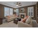 Inviting living room with a cozy fireplace, tray ceiling, and natural light at 5858 Majestic Tide Ave, Las Vegas, NV 89131