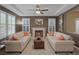 Inviting living room with a cozy fireplace, tray ceiling, and natural light at 5858 Majestic Tide Ave, Las Vegas, NV 89131