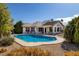 Inviting backyard pool with a spacious patio, lush landscaping, and relaxing outdoor living space at 5858 Majestic Tide Ave, Las Vegas, NV 89131