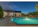 Inviting backyard features a sparkling pool, desert landscaping, and patio with chairs for enjoying the weather at 5858 Majestic Tide Ave, Las Vegas, NV 89131